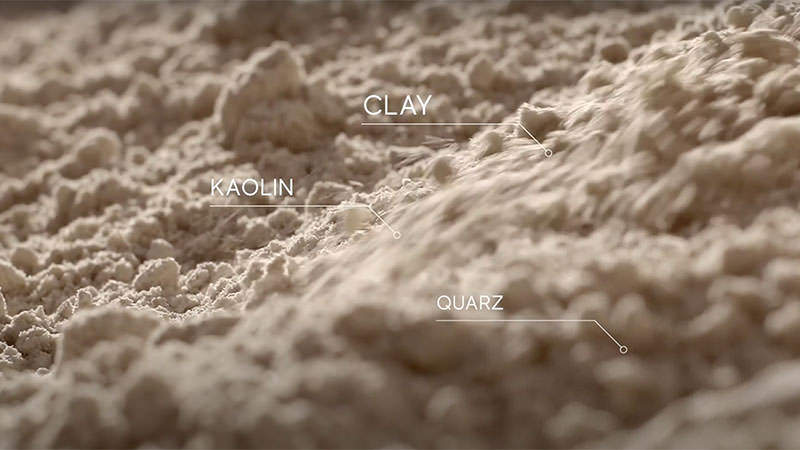 Close up of tile with tags showing clay, kaolin, and Quartz