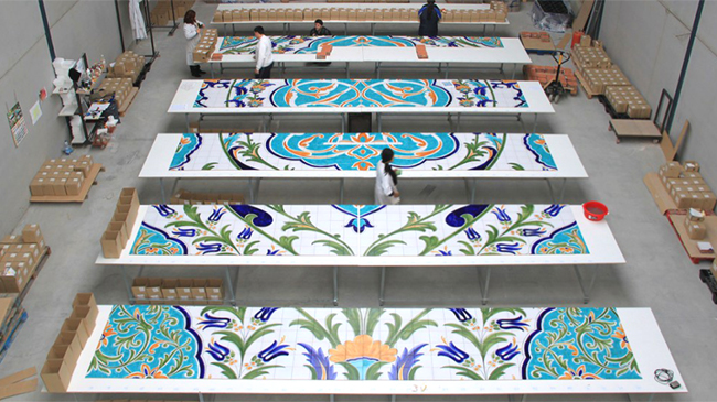Cerámica Artística San Ginés, in Talavera de la Reina, Toledo, Spain is one of the many manufacturers that winners have visited as part of the "Passport to Creativity" contest. Above, tile artists lay out a section for the world's largest hand-painted tile mural, since installed at the Oran Convention Center, in Oran, Algeria. Photo courtesy Ceramica San Ginés